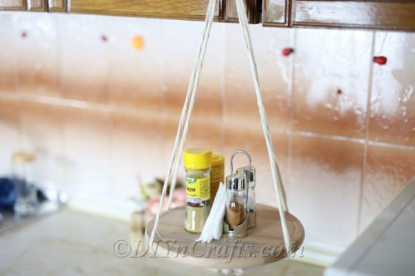 A hanging shelf with supplies in a kitchen.