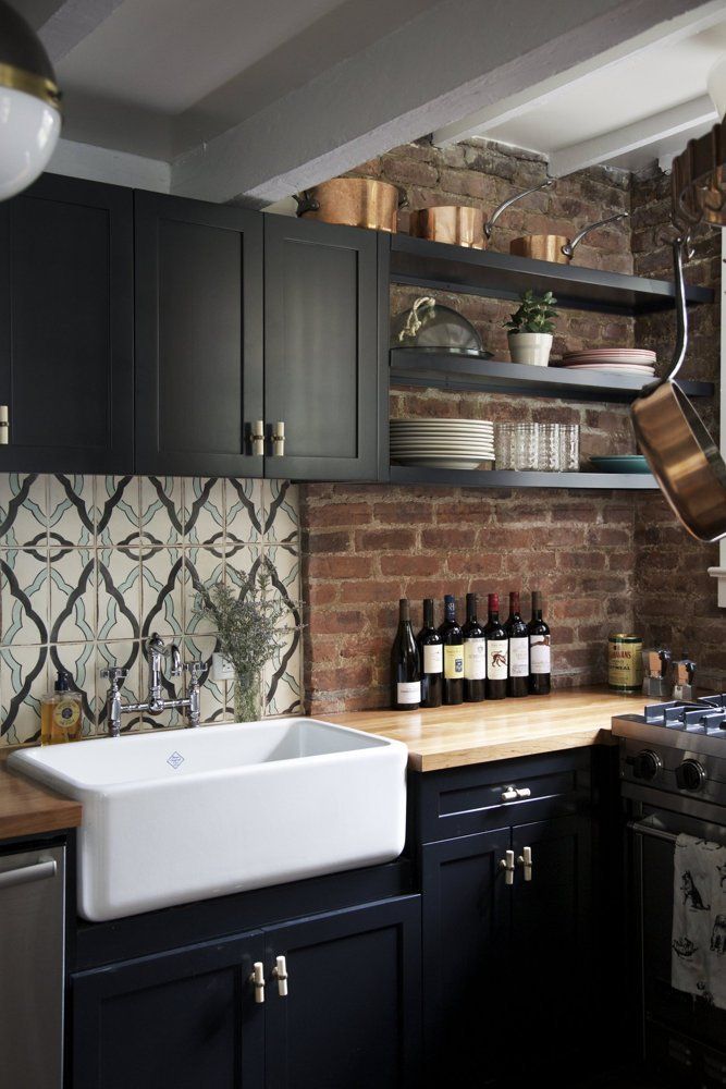 Black Farmhouse Kitchen With Exposed Brick Backsplash