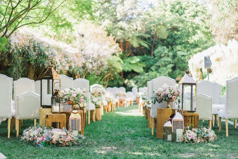 romantic outdoor wedding ceremony with blush roses and lanterns