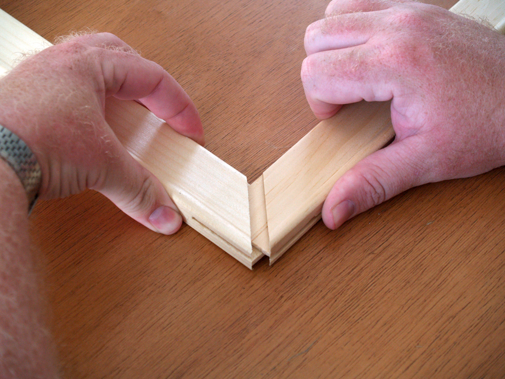 View of Hands Assembling Stretcher Corner