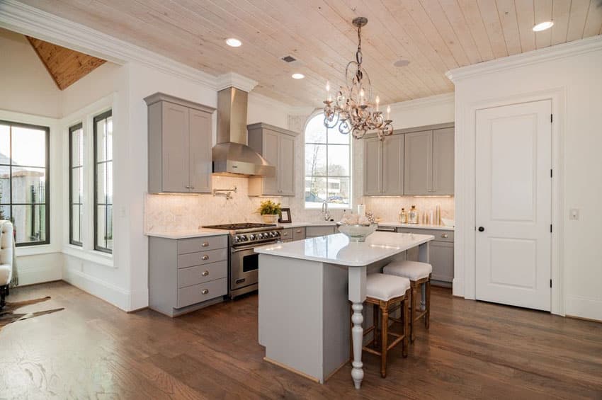 Small gray cabinet contemporary kitchen with breakfast bar island and chandelier