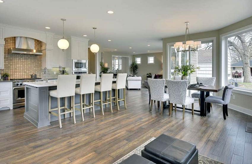 Bright open plan kitchen with muted green painted walls and dining area