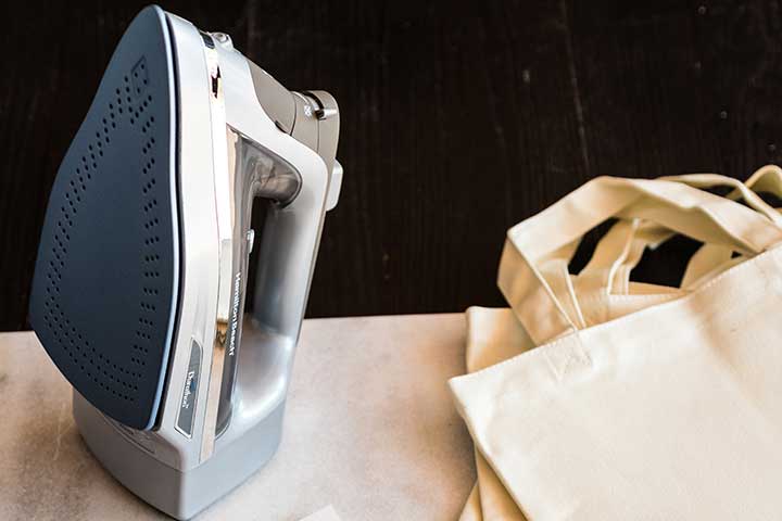 an iron sitting up on an ironing board