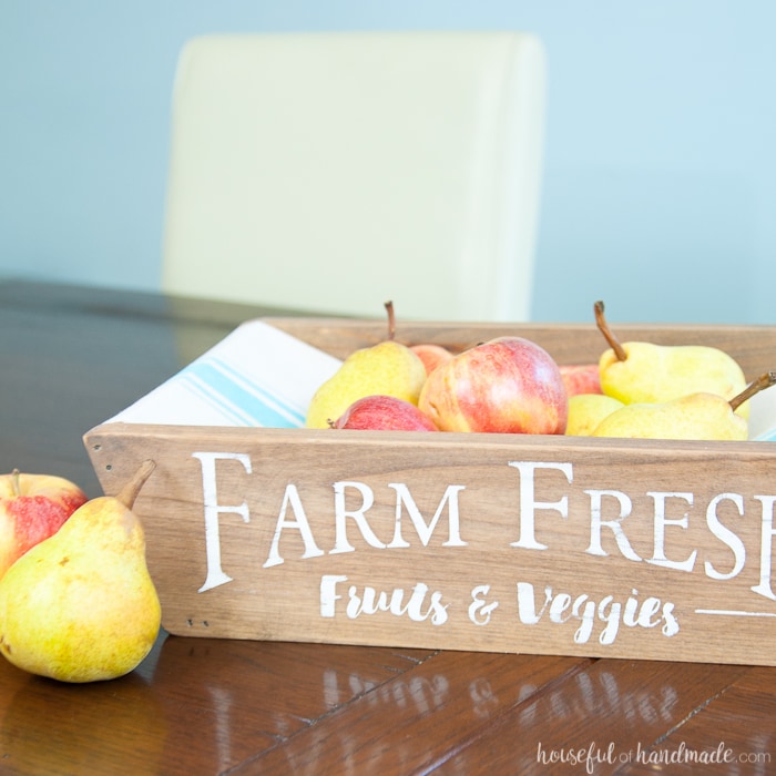 This is the most beautiful way to hold fruits and vegetables on the counter! This easy to make DIY farmhouse produce basket is a fun twist on a fruit crate. Perfect fall centerpiece to display all the produce from your garden. 