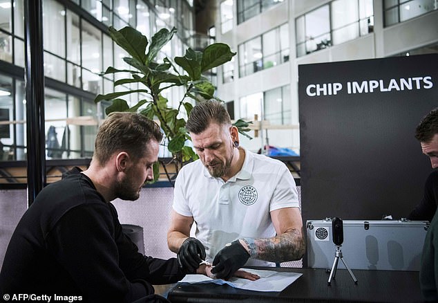 Jowan Ãsterlund (right) is a tattooist and body piercing specialist turned biohacker, who has chipped most people in the world. An electronic implant is inserted under the skin to replace keys, business cards and train tickets