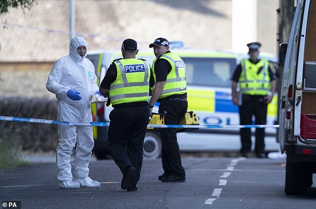Forensic officers on the Isle of Bute in Scotland last July after officers discovered the body