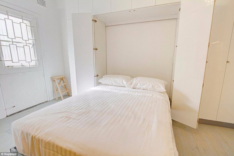 The bedroom comes complete with a double bed that folds outwards from the wall of the tiny Sydney studio apartment