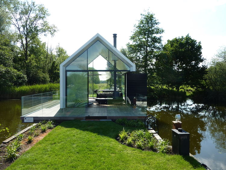 Маленький стеклянный домик у озера в Голландии