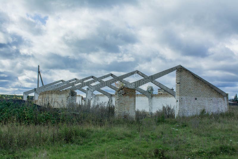 An abandoned white brick building with a triangular roof stock images