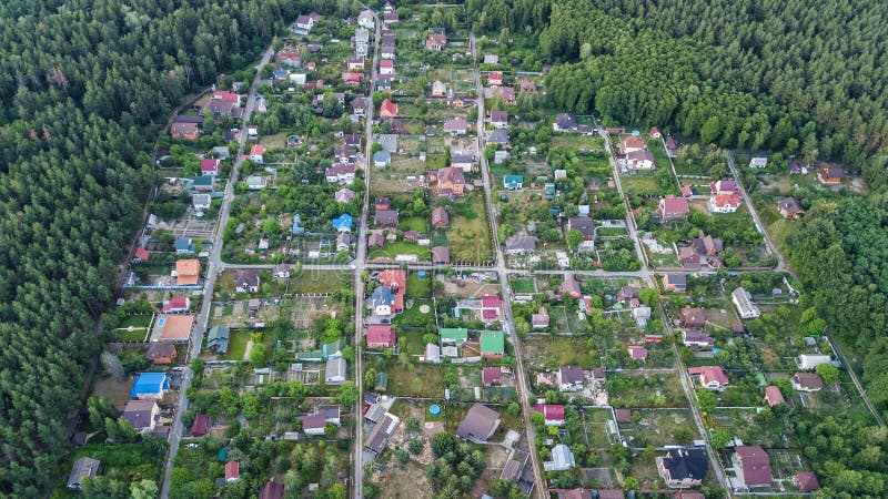 Aerial top view of residential area summer houses in forest from above, countryside real estate and small dacha village in Ukraine. Kyiv stock photography