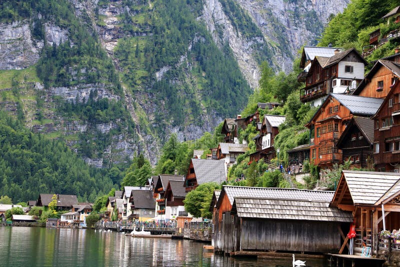 Alpine houses decorated with flowers and plants. Photo of alpine houses in Hallstatt decorated with flowers and plants at the exterior of the houses stock photography