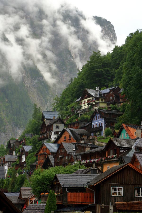 Alpine houses in Hallstatt decorated with flowers and plants. Photo of alpine houses in Hallstatt decorated with flowers and plants at the exterior of the houses stock image