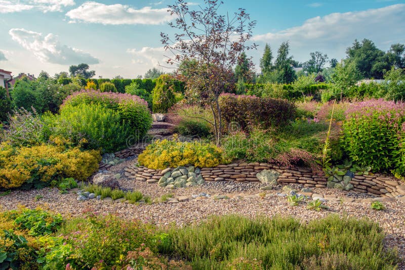 Amazing `dry stream`  - garden feature - near dacha in `Belgian village` in moscow oblas. T- awe nature in summer in russia stock photo