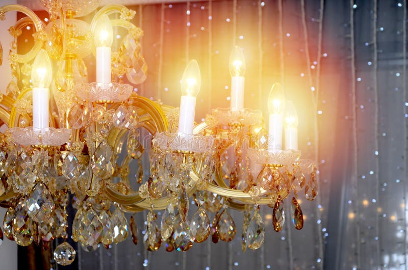 An ancient hanging retro chandelier with built-in lamps for electric lighting royalty free stock photography