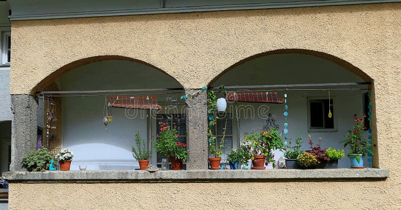 Arch balcony window with flowers and toys. In Salzburg royalty free stock photography