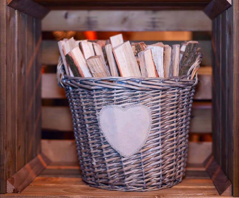 Basket with firewood. Decorative basket with firewood in wooden box stock photo