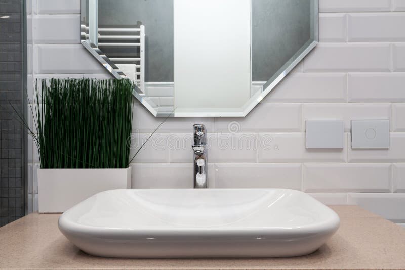 Bathroom interior. Bright bathroom with new tiles. New washbasin, white sink and large mirror. royalty free stock photography