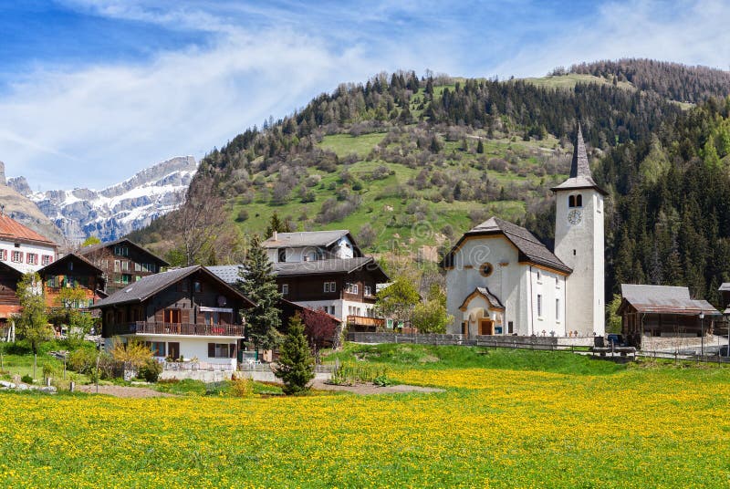 Beautiful Alpine landscape with church and typical Swiss houses at spring sunny day , Inden village , canton of Valais , Switze. Rland stock photos