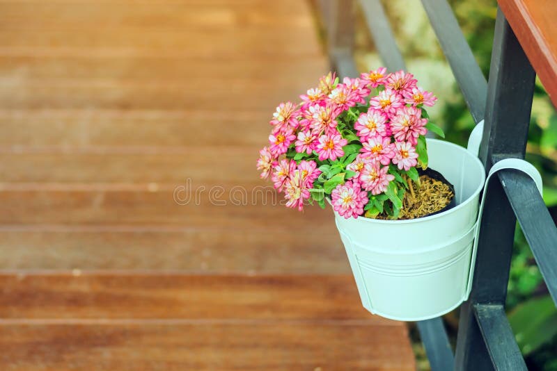 Beautiful artificial flowers in small pots hanging to decorate a railing walk for beauty on the pathway in public gardens. stock image Beautiful artificial flowers in small pots hanging to decorate a railing walk for beauty on the pathway in public gardens. stock image