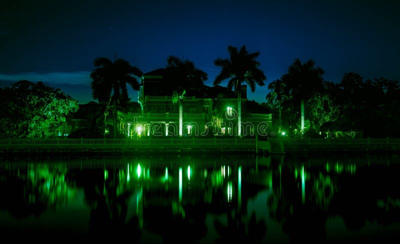 Beautiful night shot of mansion on the water stock photo