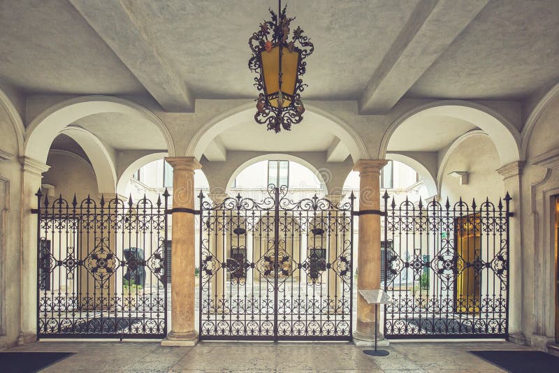 Beautiful yard with arches, forged gate and a hanging chandelier.  stock images
