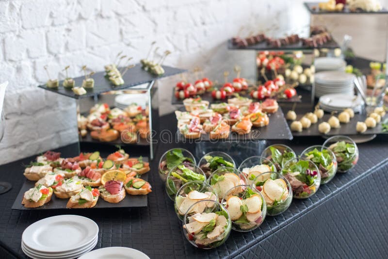 Beautifully decorated catering banquet table with different food snacks and appetizers. stock images