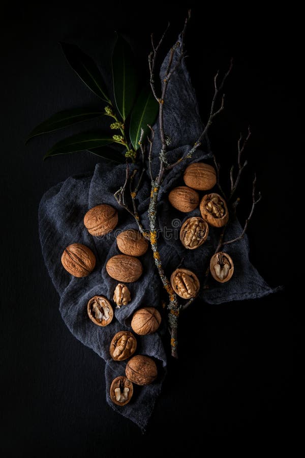 Beautifully presented walnuts on dark slate plate kitchen table stock photos