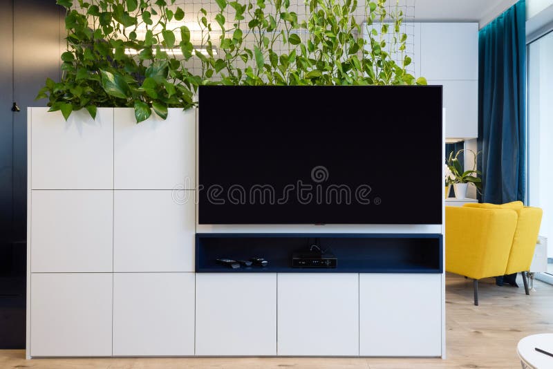 Bedroom and cabinet with TV in small modern apartment stock photo