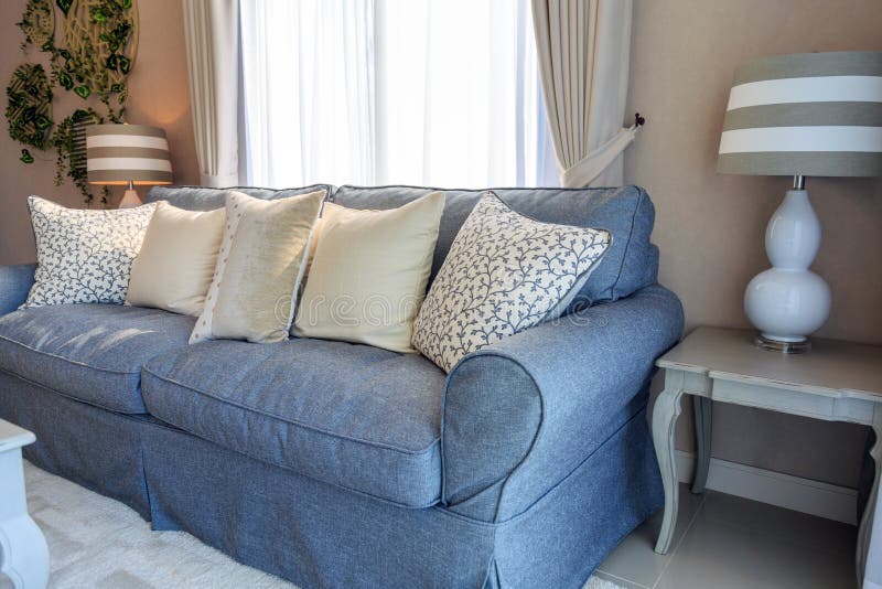 Beige pillows on blue fabric sodfa with lamp in living room. stock images Beige pillows on blue fabric sodfa with lamp in living room. stock images