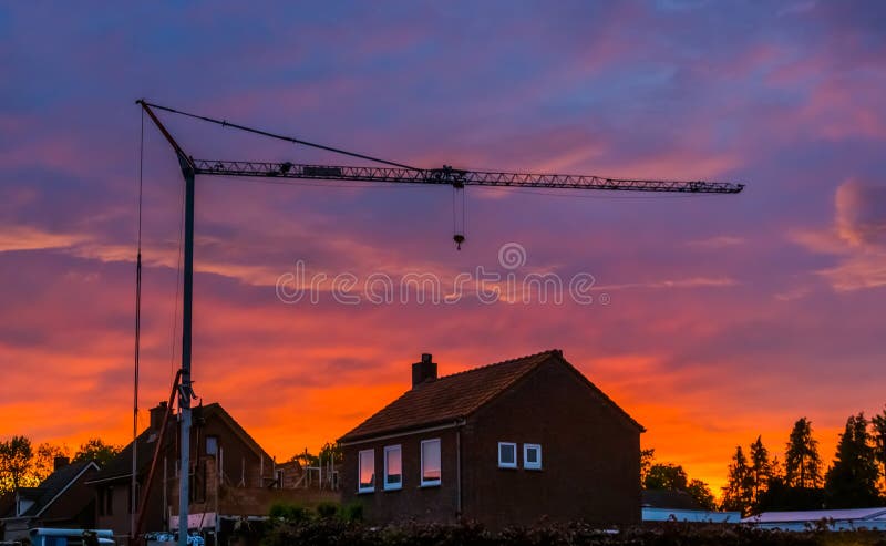 Big construction crane during sunset, building site of a house in the village of Rucphen, Architecture of the netherlands stock photo