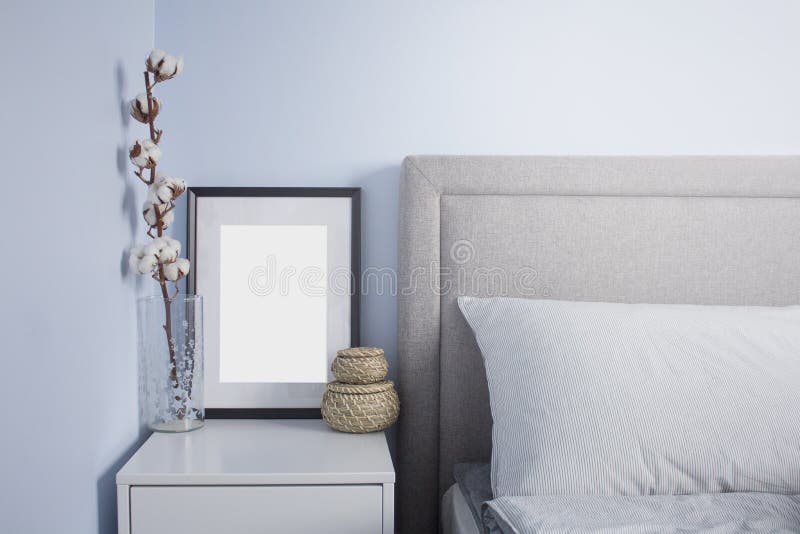 Black flame poster mockup in cozy scandinavian bedroom with blue walls. Scandinavian bedroom interior royalty free stock image