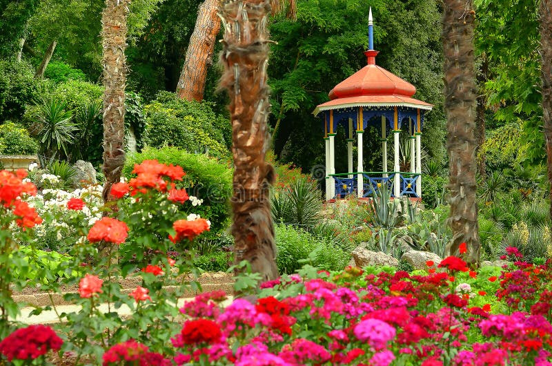 Blooming summer garden and gazebo royalty free stock photo