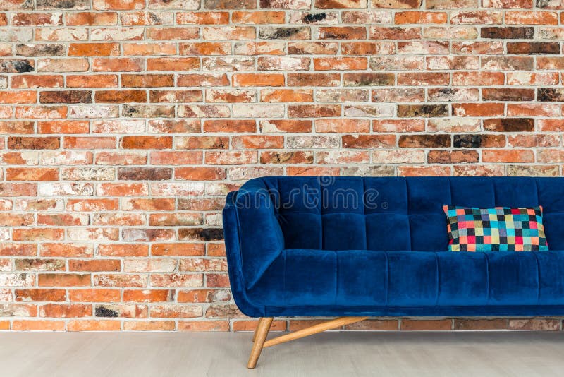 Blue sofa with patchwork pillow stock photo
