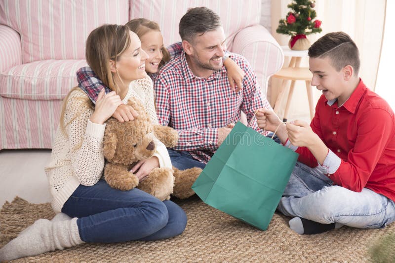 Boy opening christmas gift bag royalty free stock images