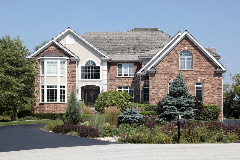 Brick home with front landscaping stock image