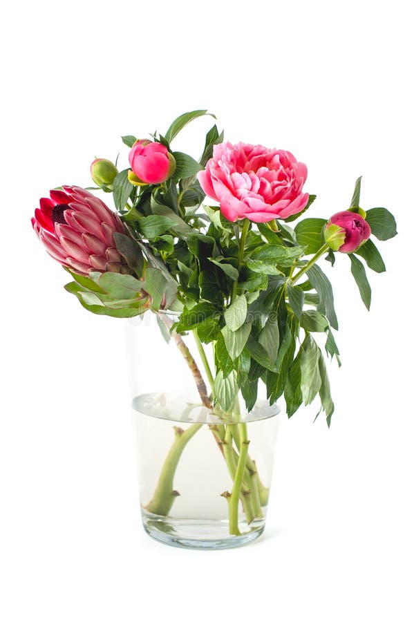 Bright bouquet of freshly cut flowers in a glass vase on a clean. Bright bouquet of freshly cut flowers in a glass vase royalty free stock image