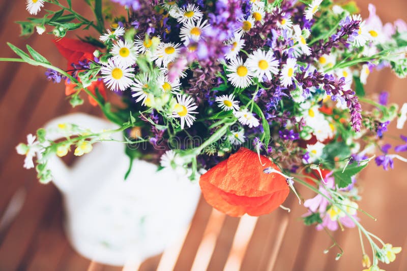 Bunch of wild herbs and flowers in a vase. Bunch of wild herbs and flowers in a white vase stock photos