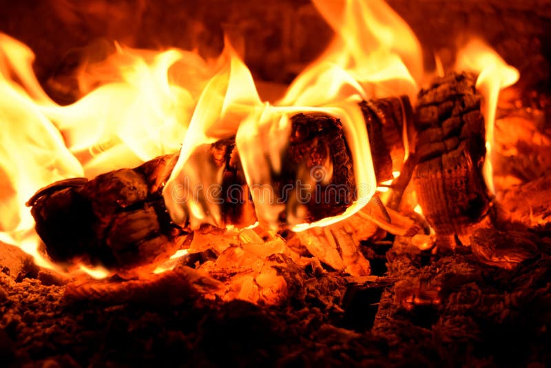 Burning firewood in stoves. Cautiously burned royalty free stock image