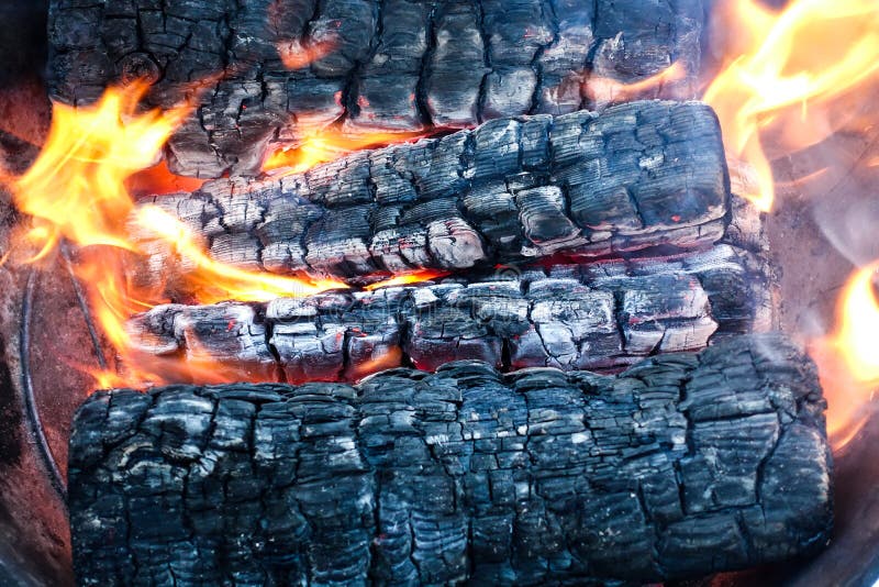 Burning wood in a firebox. Firewood turns to coal.  royalty free stock photo