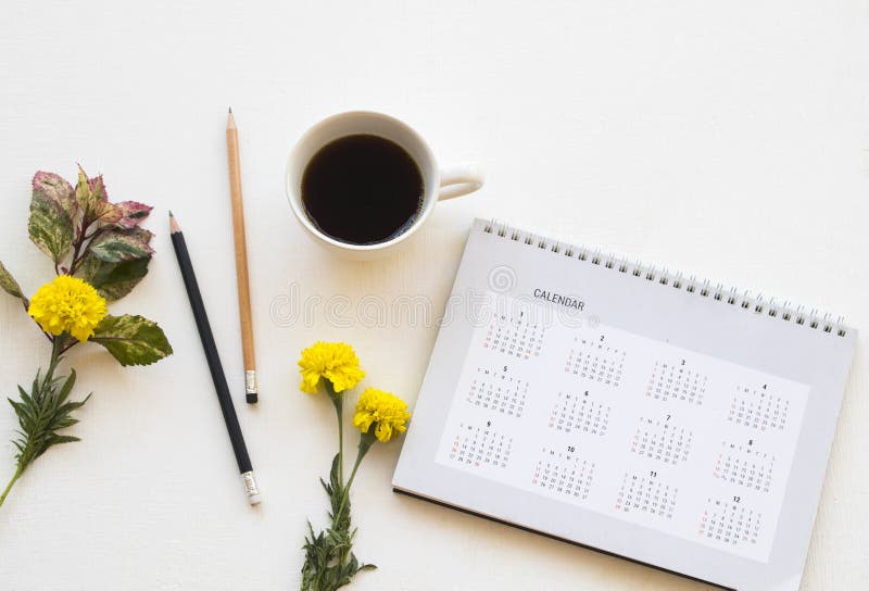 Calendar planner with hot coffee of lifestyle at office arrangement flat lay style on background white. Wooden royalty free stock photos