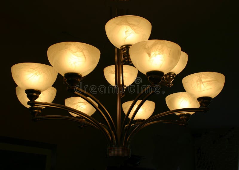 Chandelier. With eleven bowls of light against a black background stock photo