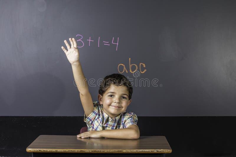 Child Raising Hand in Classroom. royalty free stock photos