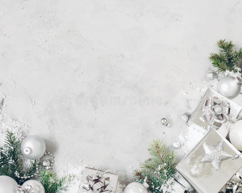 Christmas background with xmas decorations. Silver christmas gift, fir tree branch and baubles ornaments on gray stone table. stock image