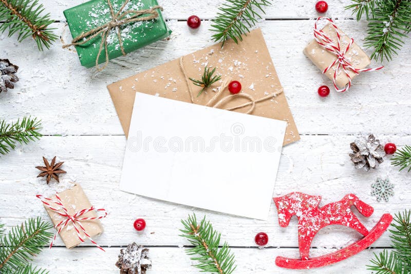 Christmas composition with blank greeting card. fir tree branches, horse toy, gift boxes and cones frame stock images Christmas composition with blank greeting card. fir tree branches, horse toy, gift boxes and cones frame stock images