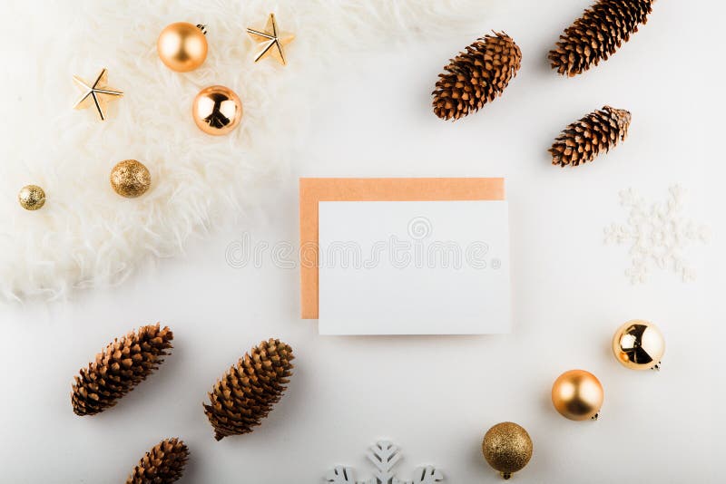 Christmas composition. Paper blank, golden decorations on white background. Flat lay, top view, copy space, square. stock photo Christmas composition. Paper blank, golden decorations on white background. Flat lay, top view, copy space, square. stock photo