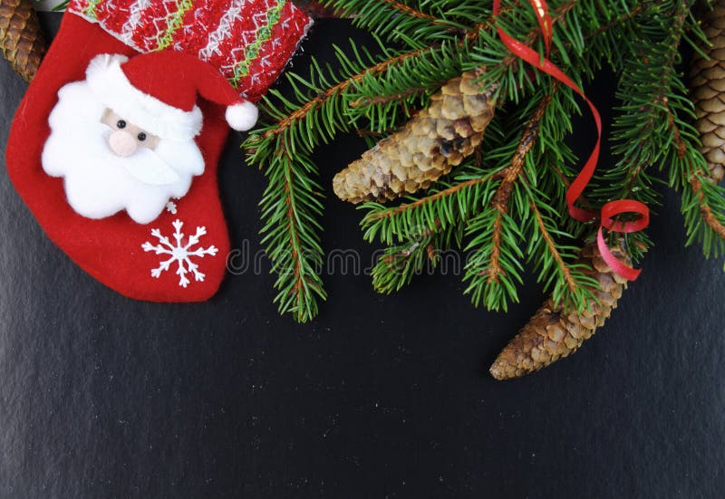Christmas composition with spruce branch with pine cones and Santa Claus stock images Christmas composition with spruce branch with pine cones and Santa Claus stock images