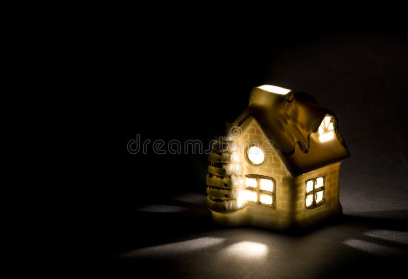 Christmas cottage. Christmas ceramic little cottage with candle inside stock image