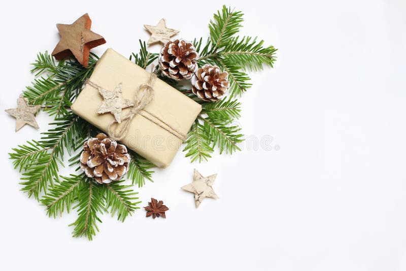 Christmas festive styled stock image composition. Handmade craft paper gift box, pine cones, wooden and anise stars and royalty free stock photography Christmas festive styled stock image composition. Handmade craft paper gift box, pine cones, wooden and anise stars and royalty free stock photography