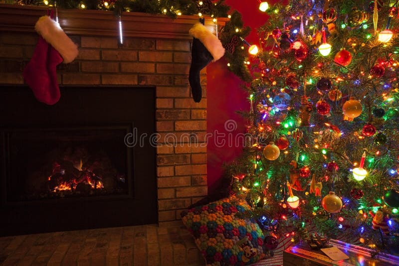 Christmas Fireplace. With stockings and Christmas tree and gifts royalty free stock photo