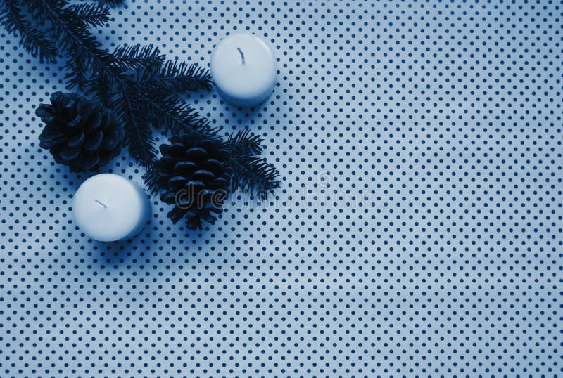 Christmas holiday celebration mock up composition of fir-tree branch, candles and pine cones toned in deep classic blue color stock photos Christmas holiday celebration mock up composition of fir-tree branch, candles and pine cones toned in deep classic blue color stock photos